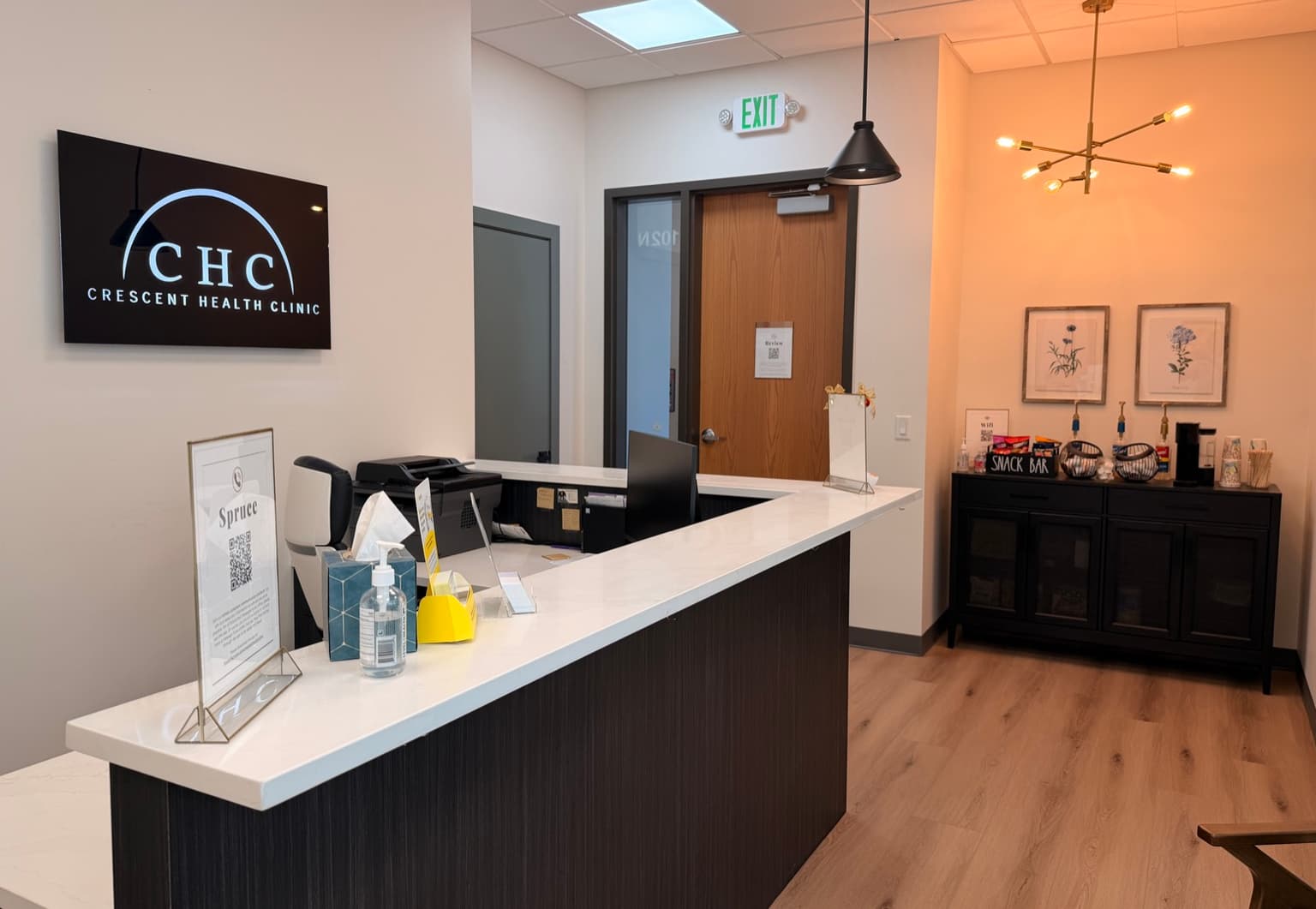 Crescent Health Clinic reception desk with CHC logo in South Jordan, Utah